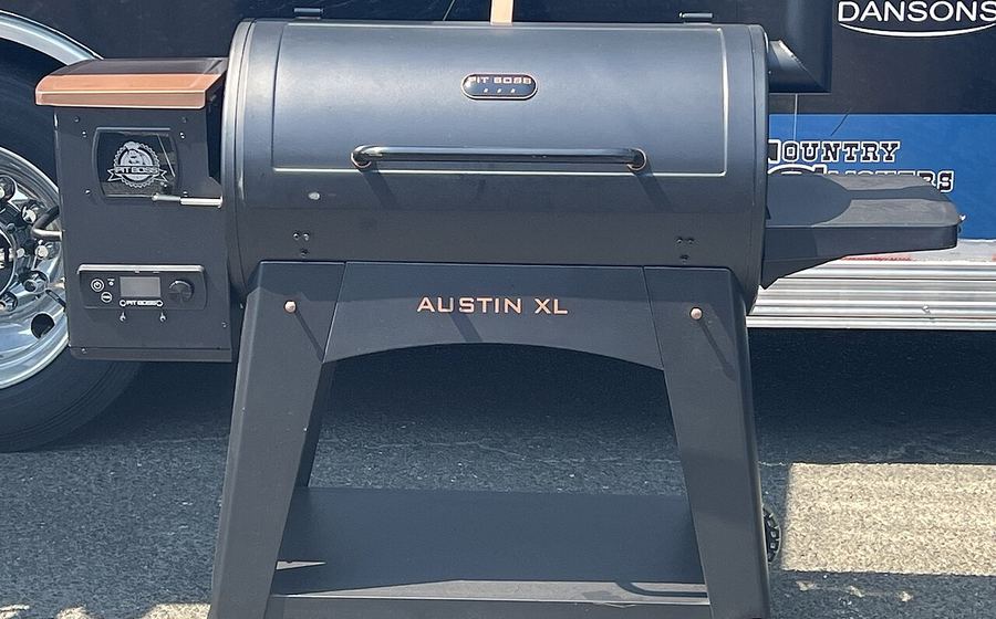 Black wood-pellet grill with hopper and side shelf (representative photo)