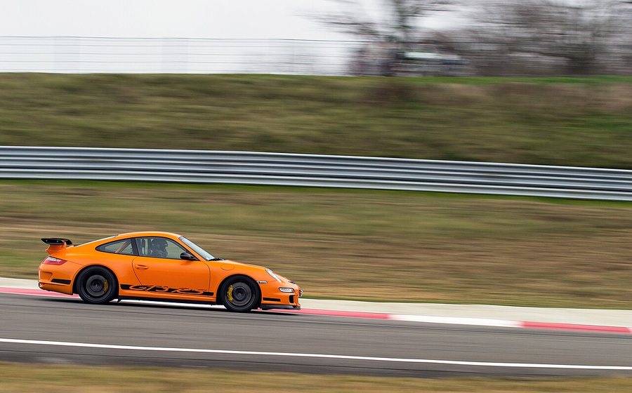 Porsche 911 GT3 sports car at speed on a race track (representative photo)